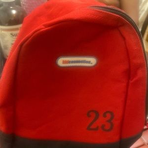 Small Kids Connection red and black 23 backpacks.